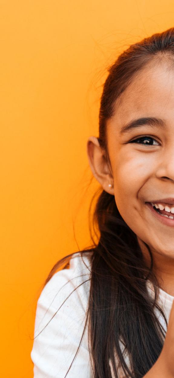 Photo of a smiling child on an orange background