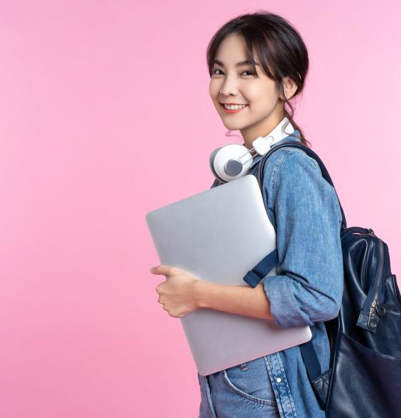 photo of a smiling high school student on pink background